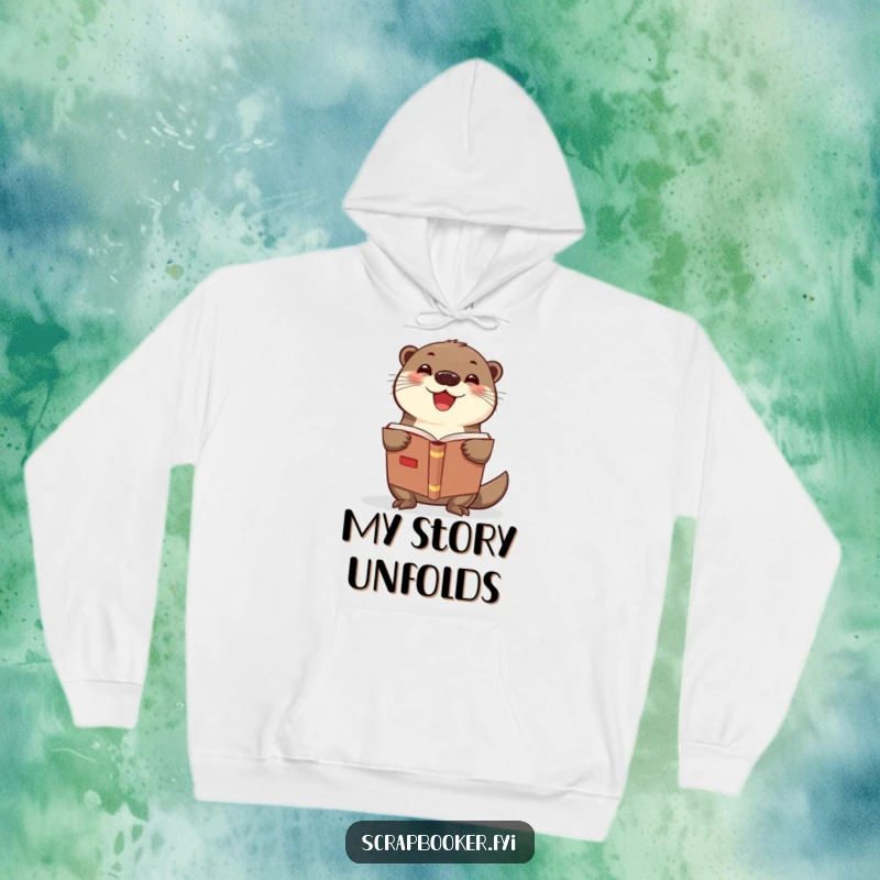 Funny otter hoodie shows a delighted otter proudly displaying a scrapbook, a cozy and humorous gift for crafters.