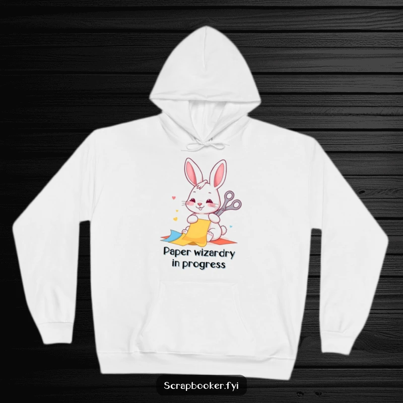 Funny hoodie with a happy rabbit diligently cutting colorful paper with scissors, perfect for cozy crafting and warm vibes.