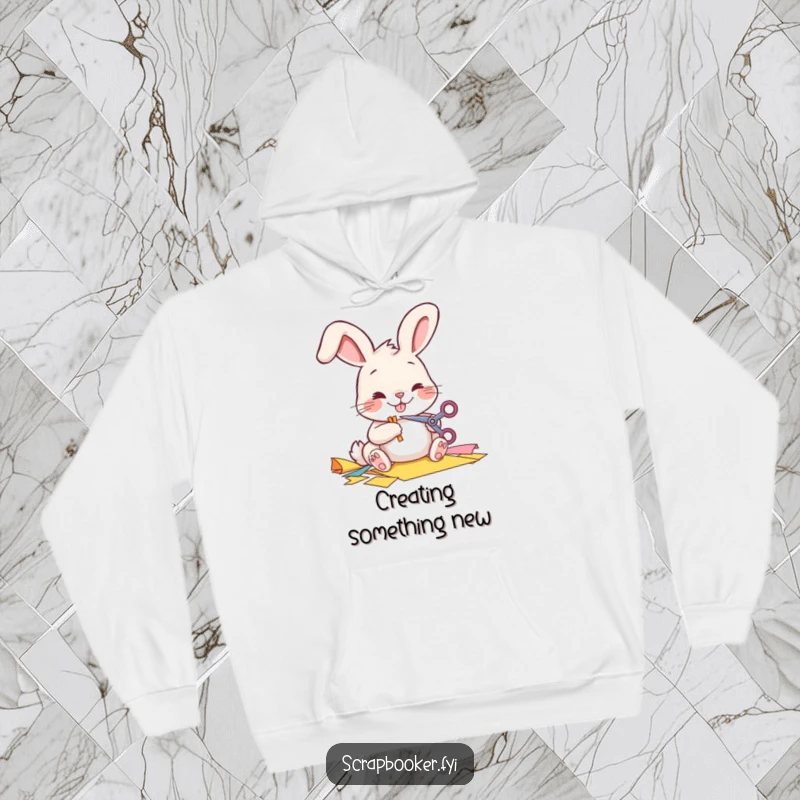 Funny Hoodie with a cheerful bunny meticulously cutting paper, ideal for cozy crafting sessions.