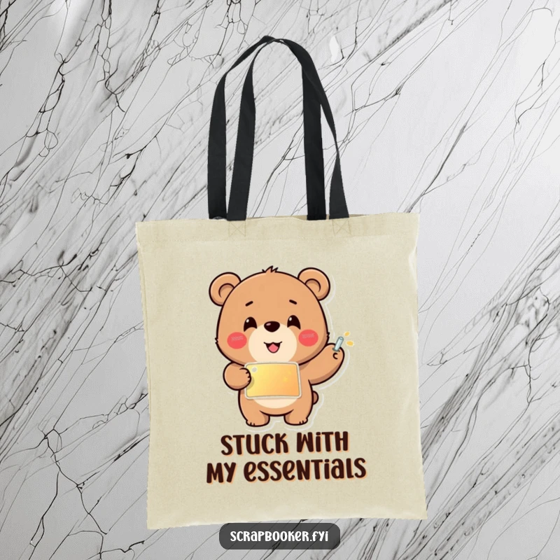 Funny tote bag featuring a cheerful bear carefully gluing a shiny sticker into place, ideal for carrying craft supplies with flair.